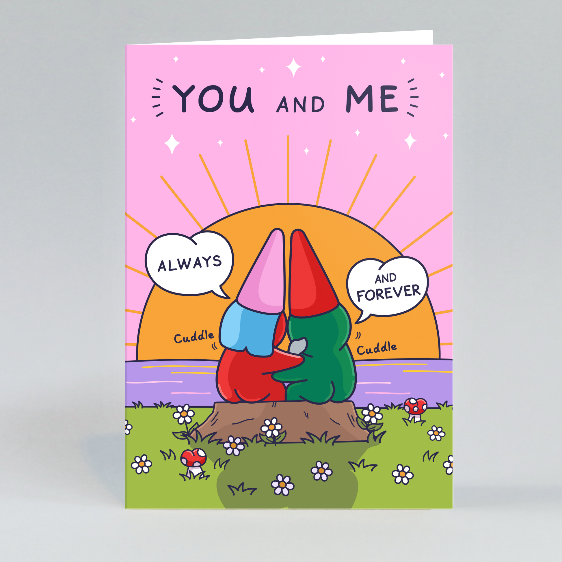 A whimsical anniversary card featuring two gnomes, one male and one female, embracing as they sit on a log. They are snuggling together while watching a sunset over a serene lake.
