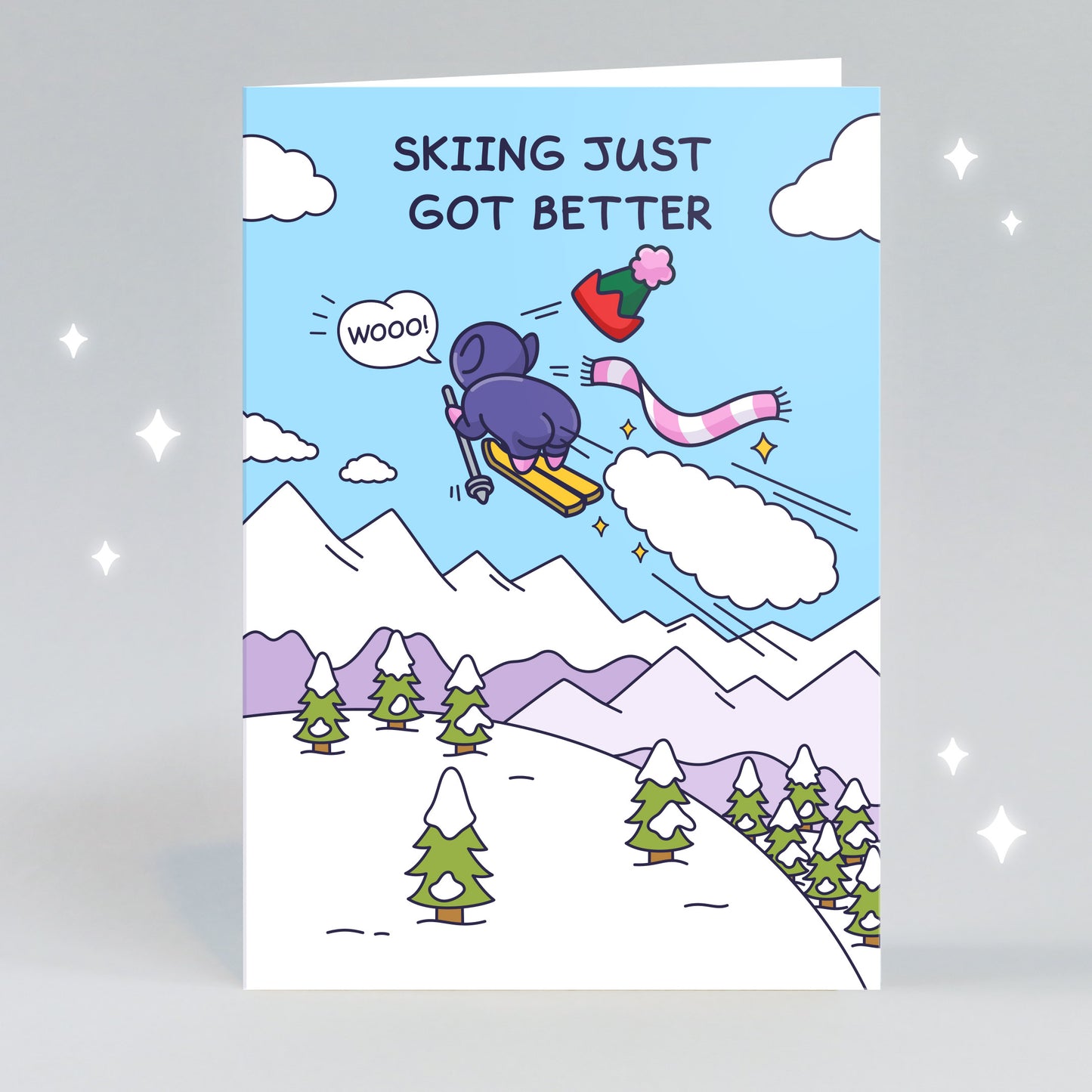 A funny greeting card of a cheeky Elf flying through the sky on skies with a huge fart cloud and stars. The caption reads 'Skiing Just Got Better'.