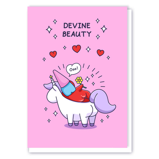 A cheeky lady gnome is laying on a unicorn with flowers, sparkles and hearts. This beautiful card has the caption 'Devine Beauty'.