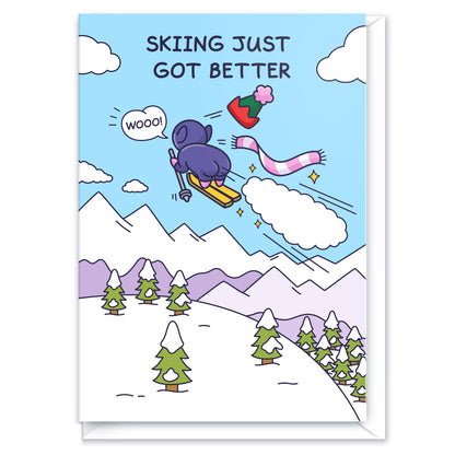 A funny greeting card of a cheeky Elf flying through the sky on skies with a huge fart cloud and stars. The caption reads 'Skiing Just Got Better'. 