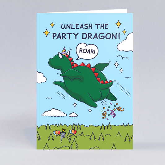 This birthday card features a dragon flying off with confetti shooting out. There are party balloons on a castle and the dragon is wearing a party hat. The caption reads 'Unleash the Party Dragon!' and the dragon is Roaring!