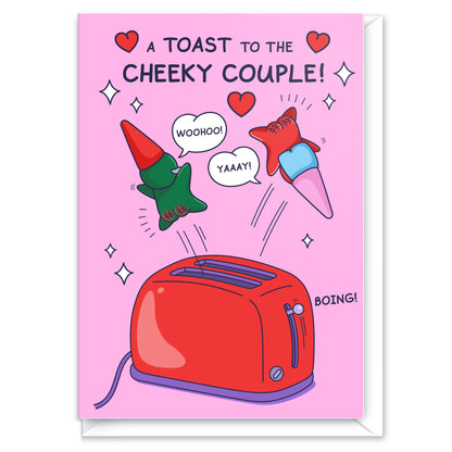 A cute gnome couple are leaping out of a toaster. The funny title reads 'A Toast to the Cheeky Couple!'