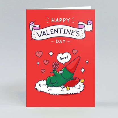 Valentine's Day card with a cartoon gnome holding a rose, laying on a rug in a sexy pose and 'Happy Valentine's Day, Grr' text.