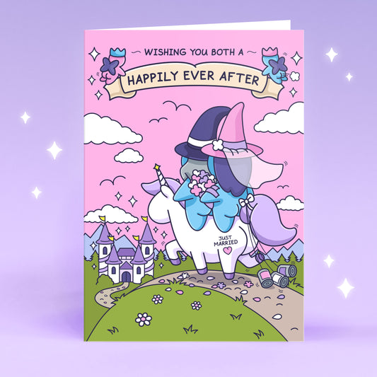 A gorgeous greeting card features a beautiful castle and a newly wedded couple riding together on a unicorn. There is a banner with the message 'Wishing you both a Happily Ever After'.