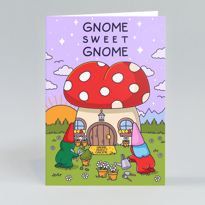 A new home card featuring a sweet illustration of a male and female gnome couple in a garden, happily planting flowers and getting their hands dirty. The scene is bright and cheerful, celebrating their new beginning.