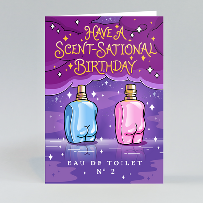 A rectangular greeting card or packaging insert shown upright on a light gray studio background. The front features a purple illustrated design with the text 'HAVE A SCENT-SATIONAL BIRTHDAY' in yellow, two cartoon buttock-shaped perfume bottles (one blue, one pink), and 'EAU DE TOILET N°2' at the bottom.