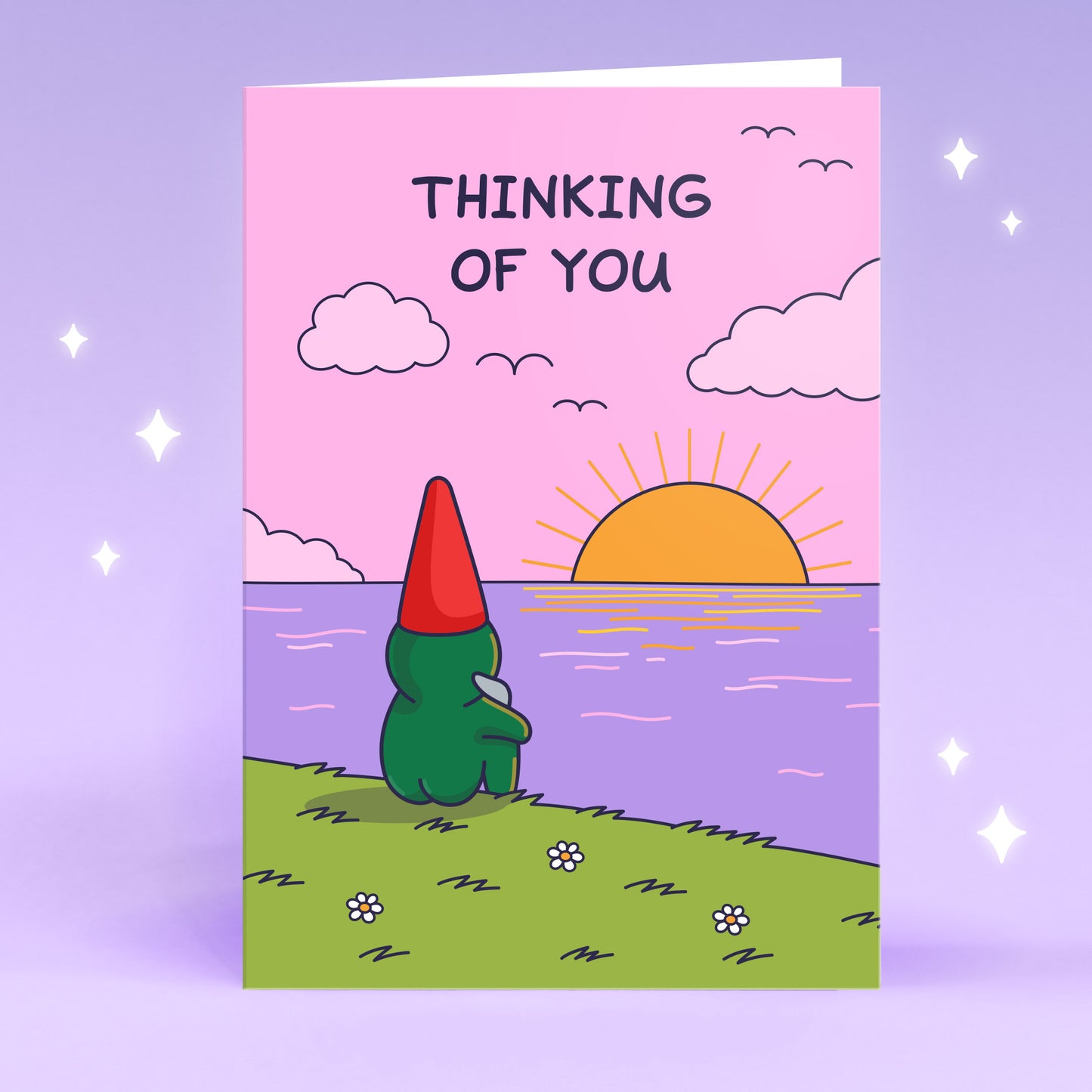 A sweet gnome is overlooking the sea with a sunset. The mood is calm and gentle breeze. The caption reads  'Thinking of You', this greeting card can be used to send someone they are thinking about them.