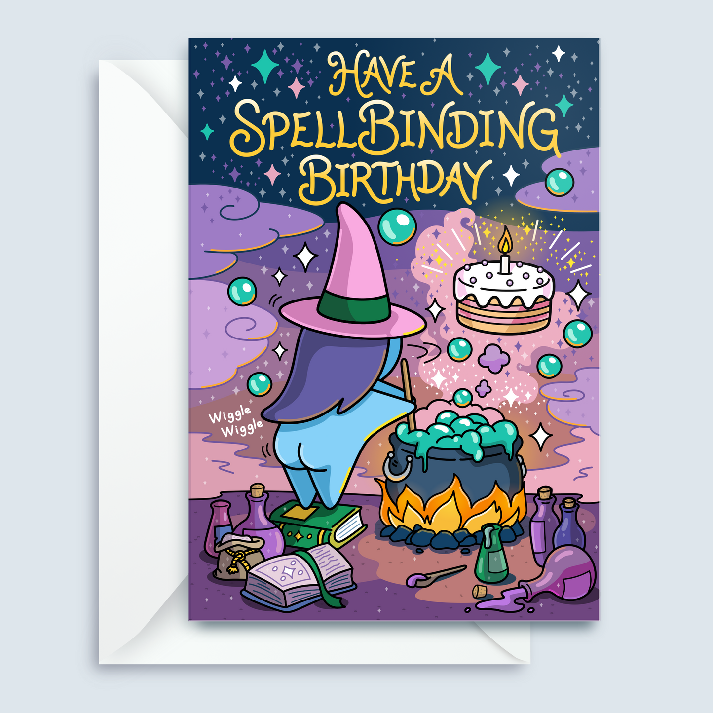 A whimsical illustrated birthday card with an envelope behind it. The card shows a purple-haired witch in a pink hat standing by a cauldron of green potion, with a birthday cake floating nearby and the text 'HAVE A SPELLBINDING BIRTHDAY' at the top.